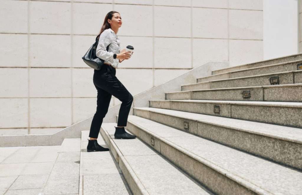 Business woman commuting on lunch hour with coffee on way to beauty treatment